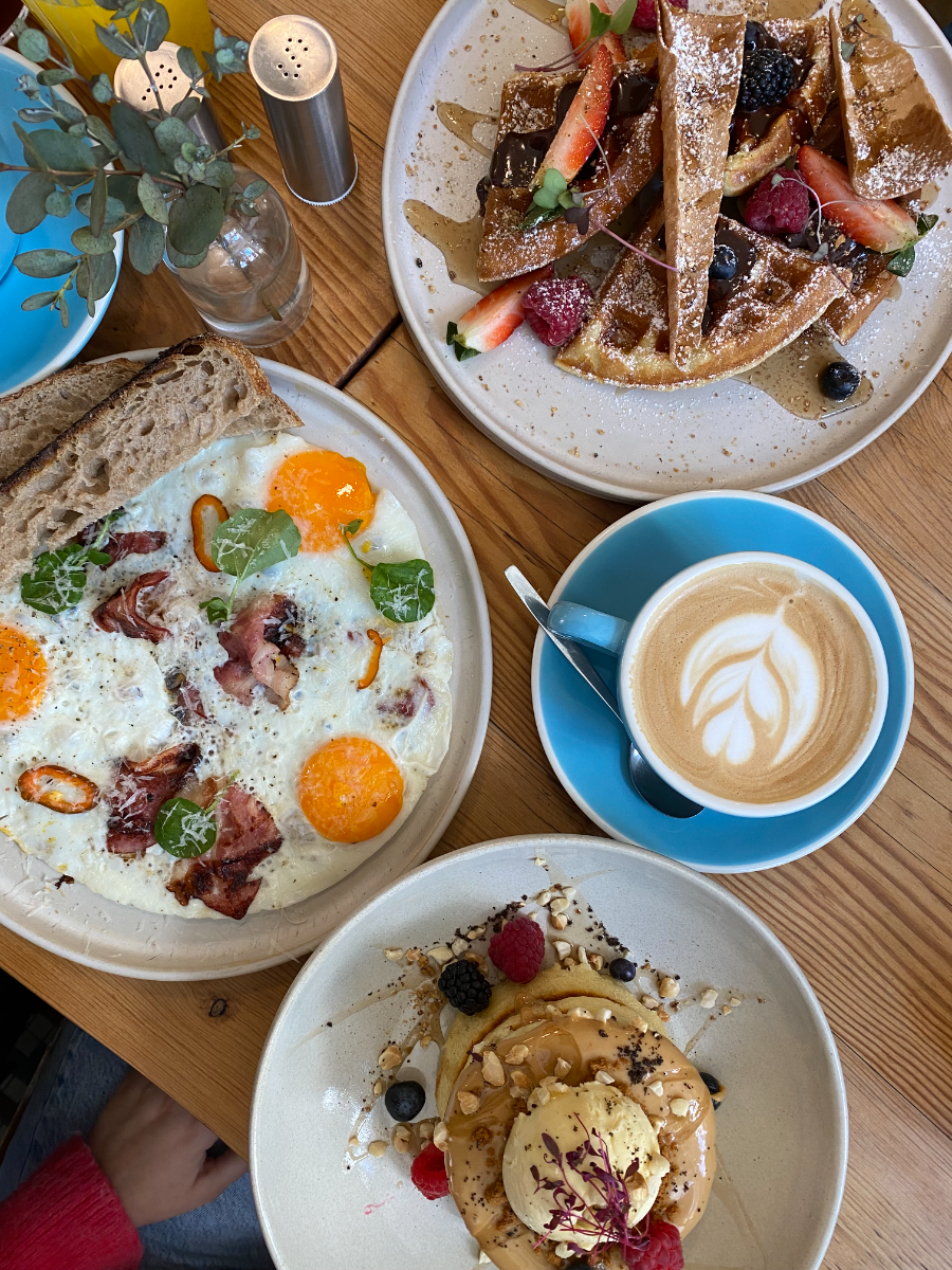 Eggs on toast, waffles and a latte